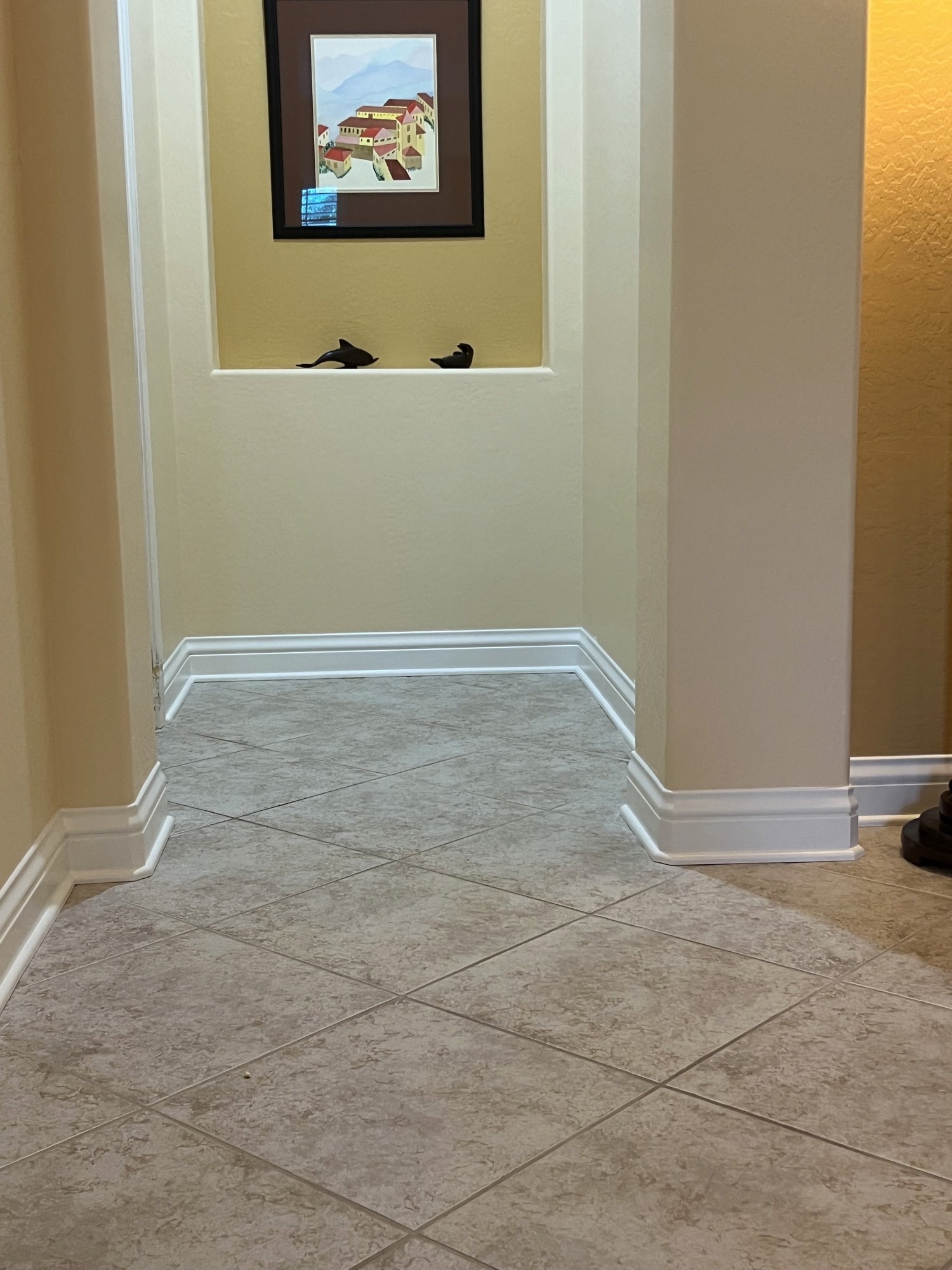 Finished baseboard trim in a hallway