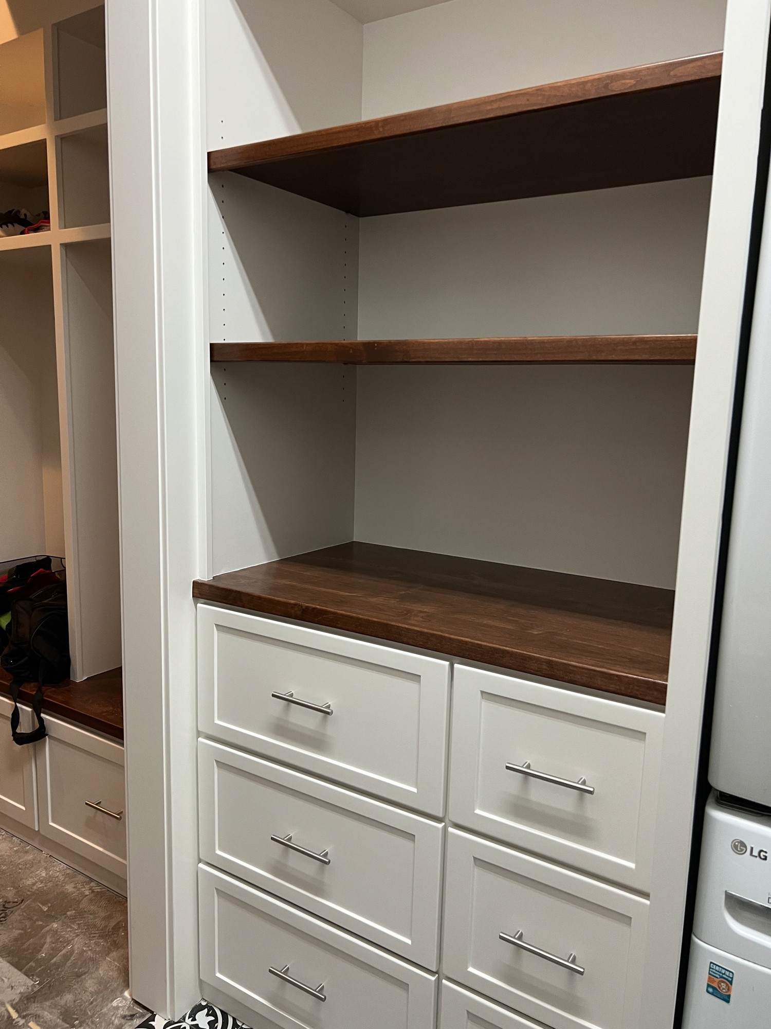 Mudroom storage built-in with drawers and open shelving